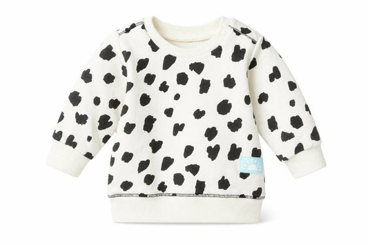 Front view of Primark girls’ white polka dot jumper, size 3-6, months
