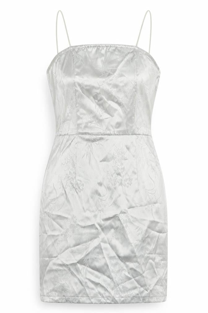 Front view of PRETTYLITTLETHING women’s silver mini, size UK 4