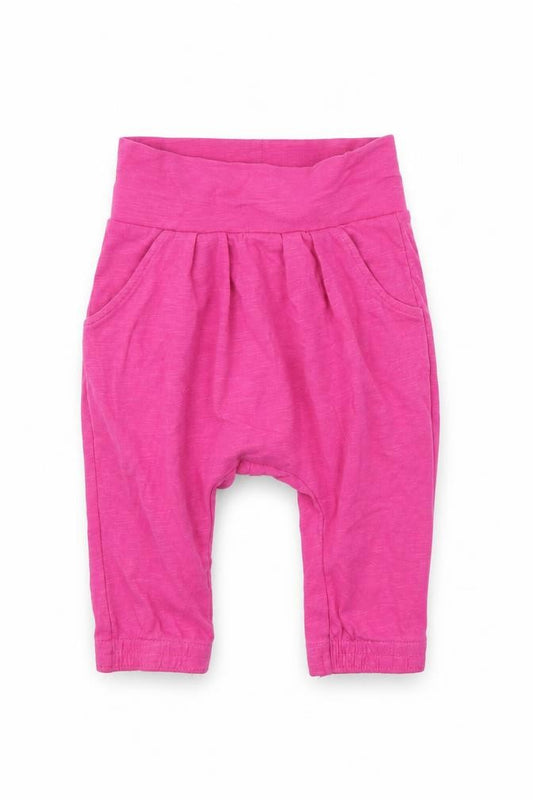Front view of Nutmeg girls’ pink jogger trousers, size 3-6, months