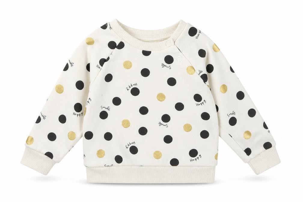 Front view of Primark girls’ ivory polka dot jumper, size 6-9, months