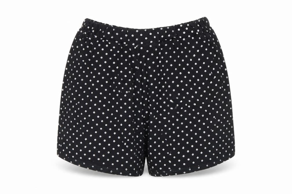 Front view of PRETTYLITTLETHING women’s black polka dot culotte shorts, size UK 8