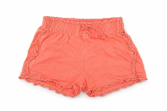 Front view of Tu girls’ orange shorts, size 6, years