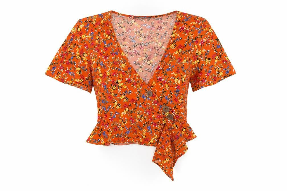 Front view of Primark women’s orange floral cardigan jumper, size UK 6