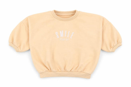 Front view of Matalan girls’ orange cotton jumper, size 12-18, months - smile everyday