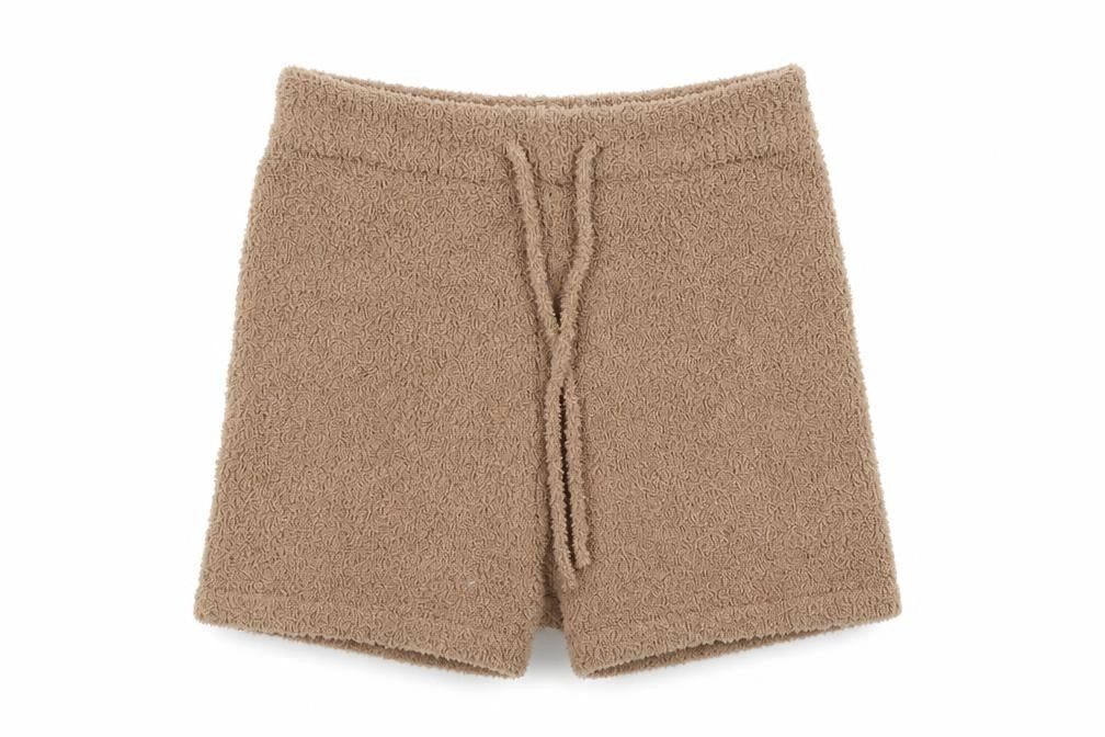 Front view of PRETTYLITTLETHING women’s beige polyester compression shorts, size M, regular pull on