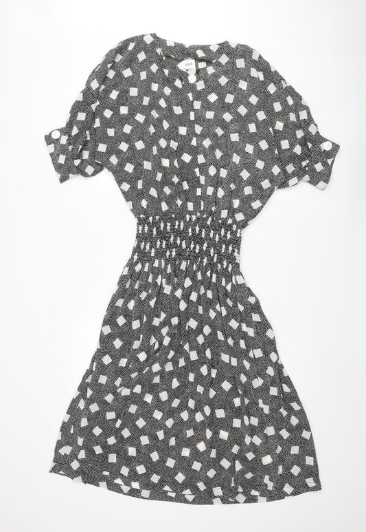 Front view of BHS women’s black polka dot polyester a-line, size UK 12, round neck button - square pattern
