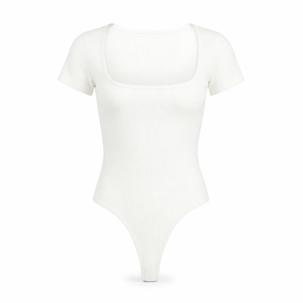 Front view of Cider women’s white polyester bodysuit one-piece, size XS, snap