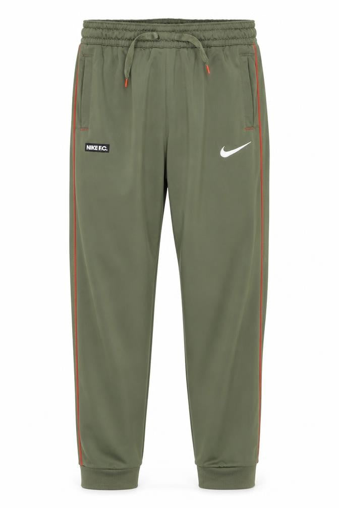 Front view of Nike boys’ green track pants m athletic fit