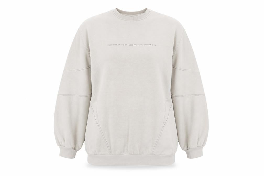 Front view of PRETTYLITTLETHING women’s beige logo sweatshirt, size UK 12, pullover