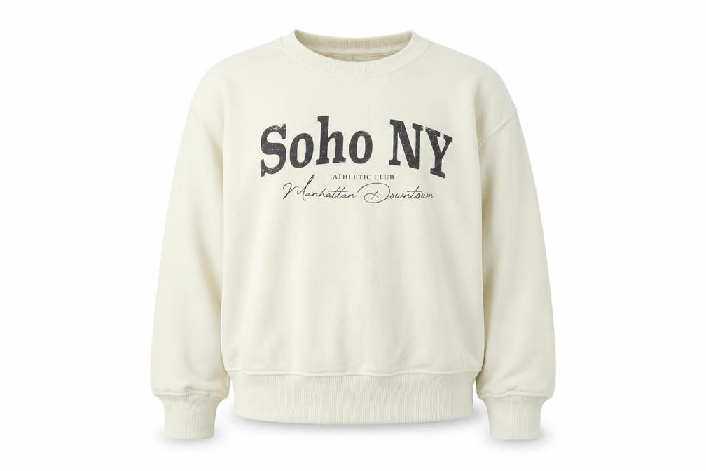 Front view of Dunnes girls’ beige soho ny graphic pullover sweatshirt 6-7 years