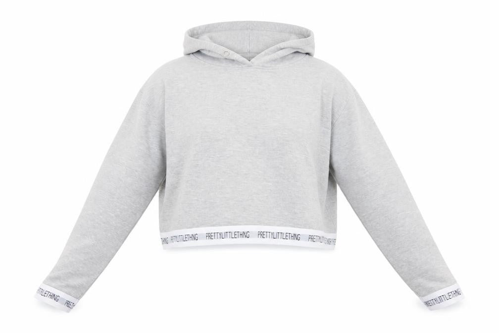 Front view of PRETTYLITTLETHING Women’s Grey Cropped Hoodie, size M, Pullover Logo Trim