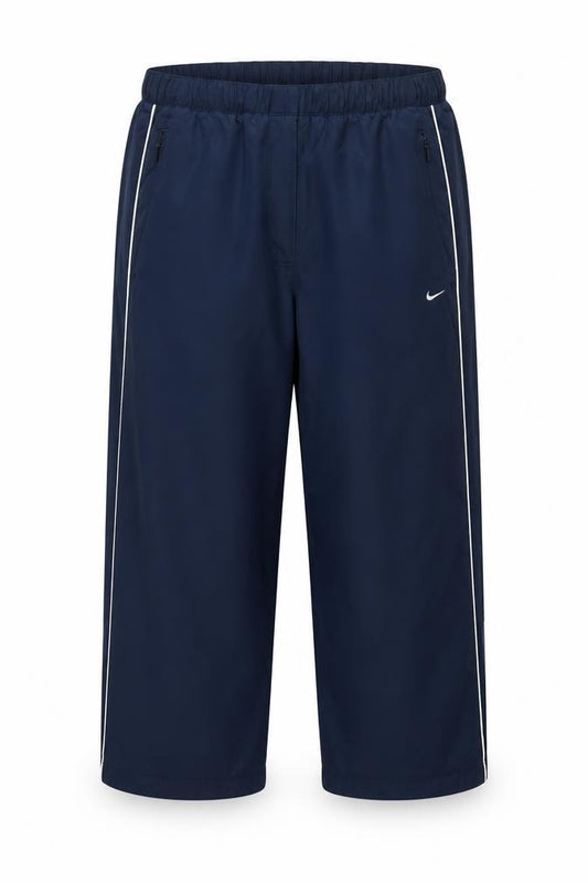 Front view of Nike boys’ blue track pants s lightweight activewear trousers