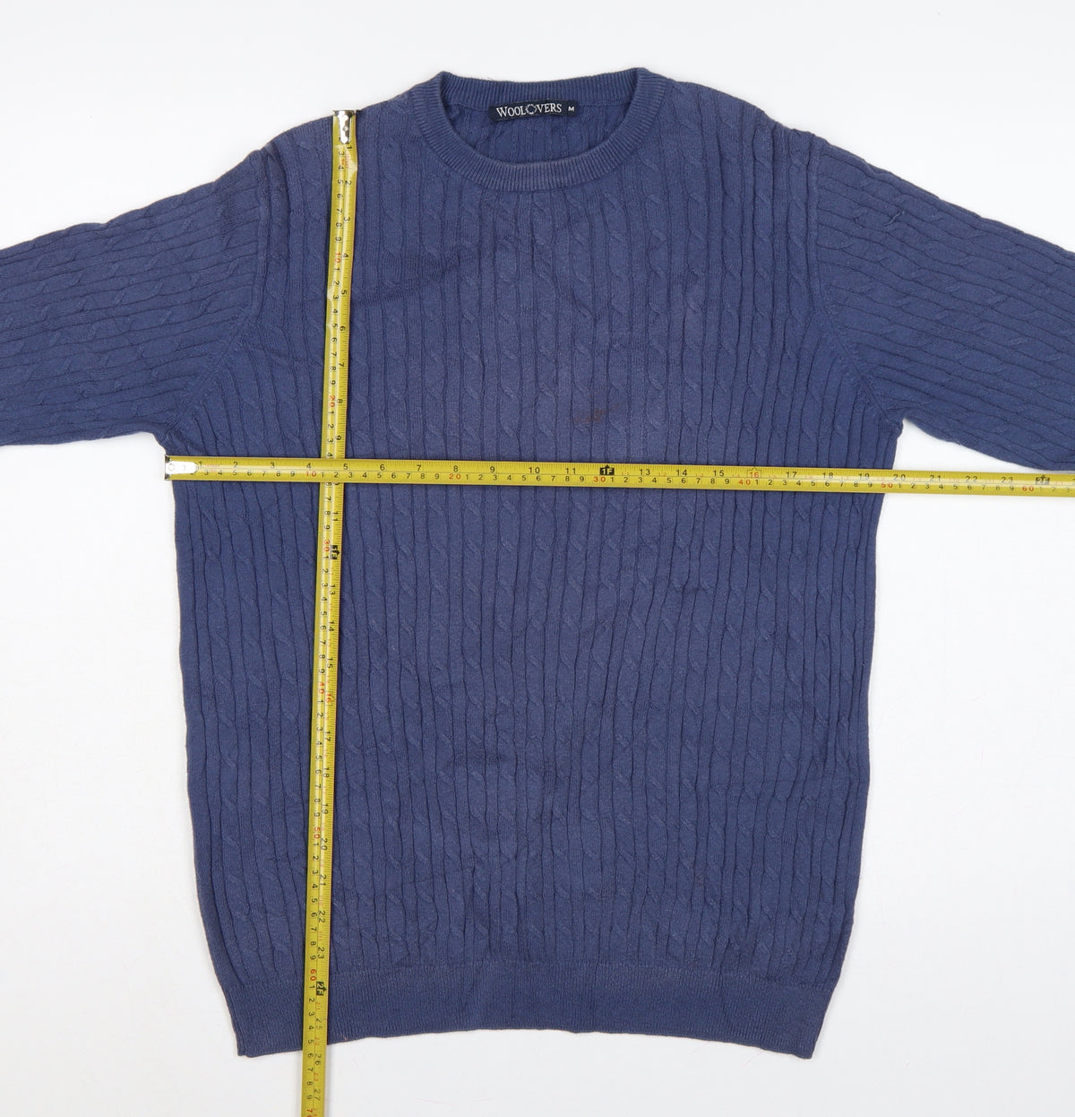 Close-up detail of WoolOvers men’s blue m cable knit crew neck long sleeve jumper
