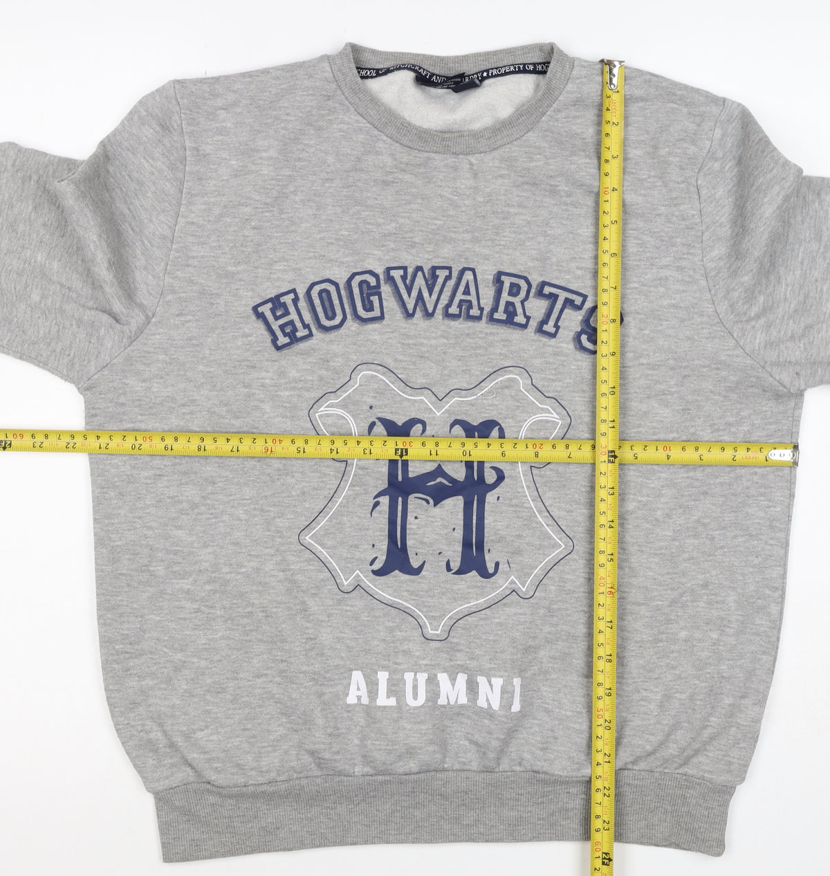 Close-up detail of Harry Potter women’s grey m hogwarts alumni fleece pullover sweatshirt