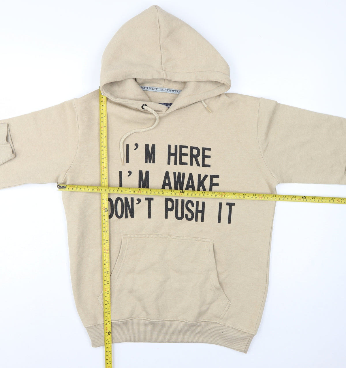 Close-up detail of North West Women's Beige M Pullover Hoodie Slogan Graphic Fleece