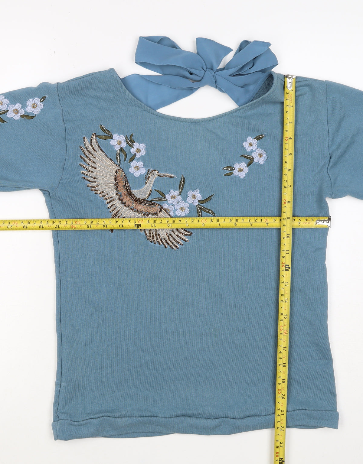 Brand and care label for Naf Naf Women’s Blue S Embroidered Beaded Bird Tie Back Sweatshirt