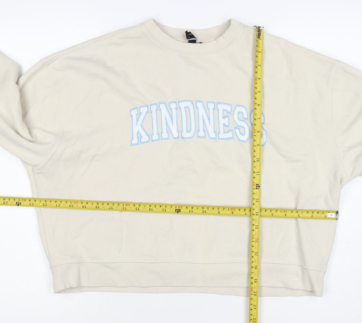 Brand and care label for Nobody's Child Women’s Ivory M Kindness Embroidered Sweatshirt