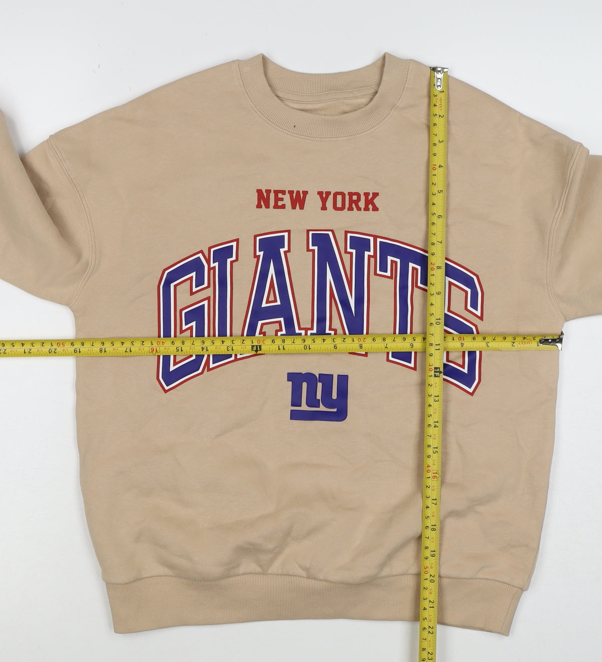 Brand and care label for NFL boys’ beige new york giants graphic print pullover sweatshirt 10-11 years