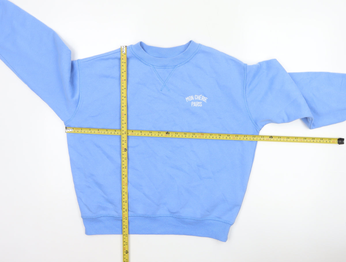Close-up detail of H&M Women Blue XS Pullover Sweatshirt Mon Chérie Paris Crew Neck