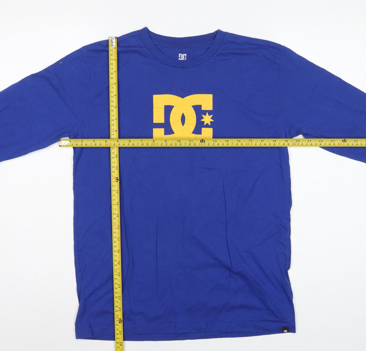 Close-up detail of DC boys’ blue yellow logo graphic long sleeve pyjama top age 16