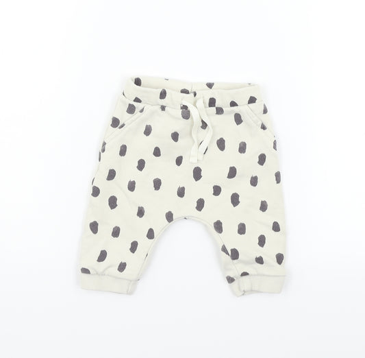 Front view of Marks & Spencer boys’ beige animal print jogger trousers, size 3-6, months