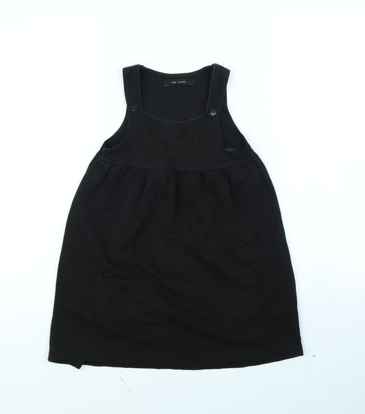 Front view of Top Class girls’ black pinafore/dungaree dress, size 5, years