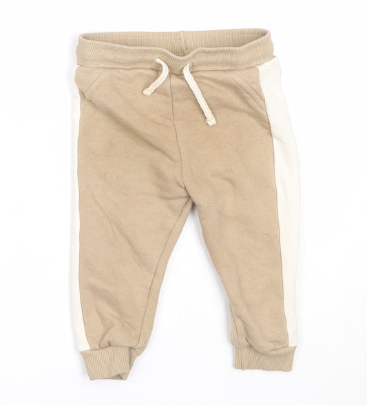 Front view of F&F boys’ beige cotton jogger trousers, size 6-9, months