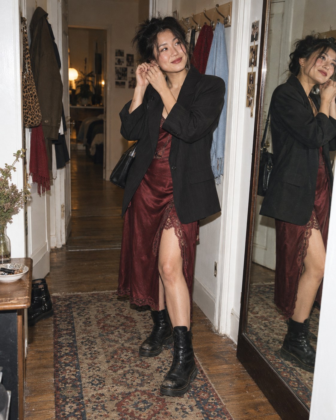 Woman styling a vintage slip dress with a blazer and boots